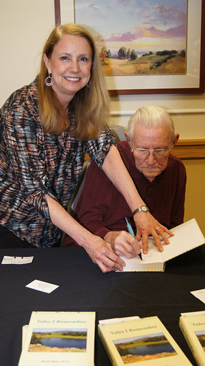 Basil Moss signs Tales I Remember at his booksigning party